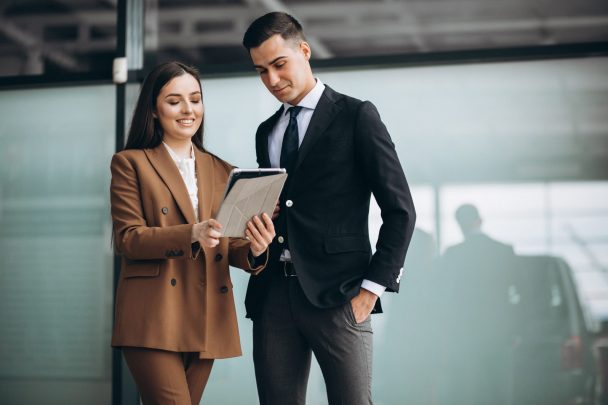 Male and female business people working on tablet in office